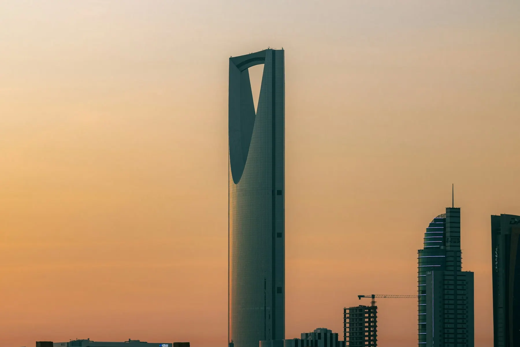 Kingdom Centre rising above Riyadh against a warm evening sky